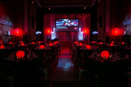A large room with tables and red lights.