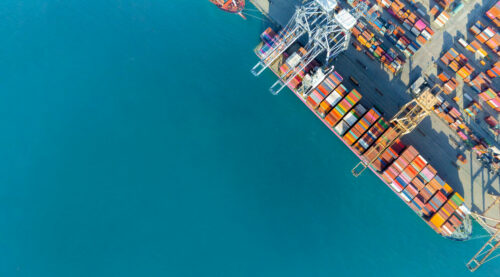 cargo ship and truck at seaport waiting for container dock crane