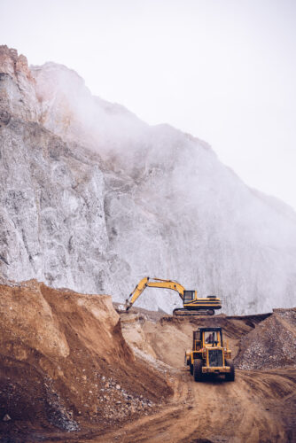 loader and excavator at work in a stone quarry