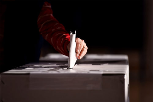 Hand-casting-a-vote-into-the-ballot-box-1