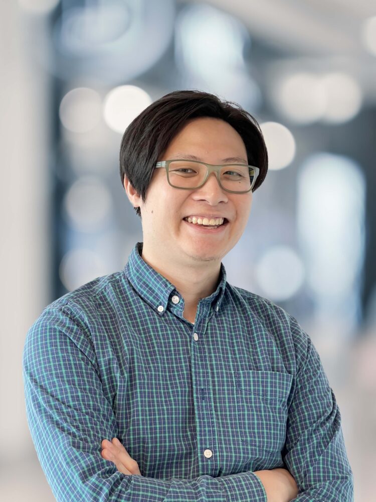 Jeff Law, a smiling asian man wearing glasses and a checkered shirt.