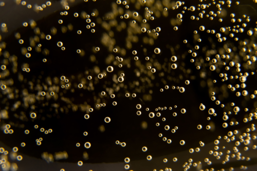 A close up of bubbles in a glass.