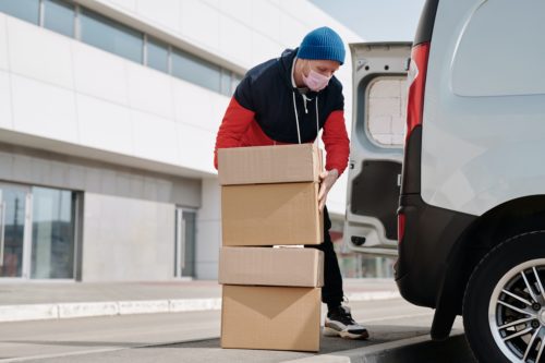A man loading boxes into a van.